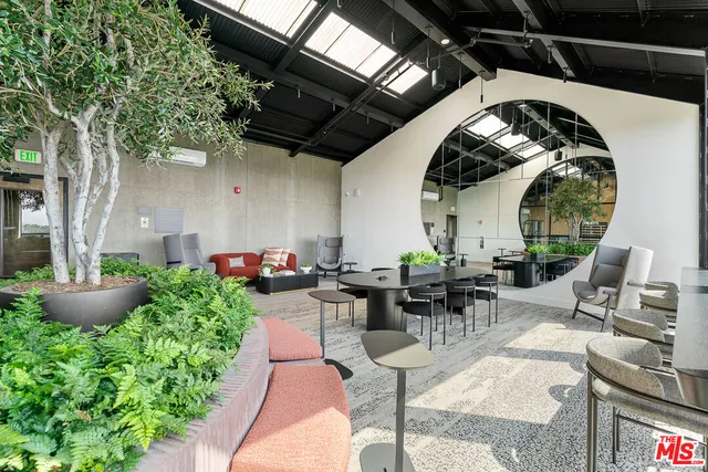 a living room with furniture fireplace and floor to ceiling windows