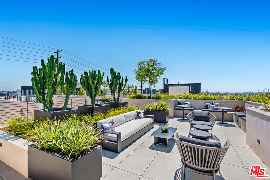 10700 Tabor Street, Unit 512 Los Angeles, CA 90034 - Photo 21 of 29 a view of a patio with couches chairs and a potted plants