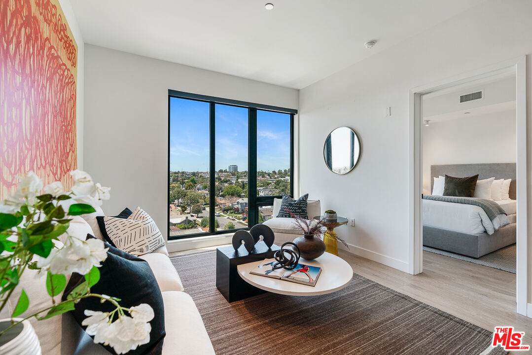 10700 Tabor Street, Unit 512 Los Angeles, CA 90034 - Photo 7 of 29 a living room with furniture and a wooden floor