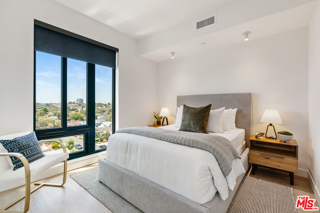 10700 Tabor Street, Unit 512 Los Angeles, CA 90034 - Photo 10 of 29 a bedroom with a bed and large windows