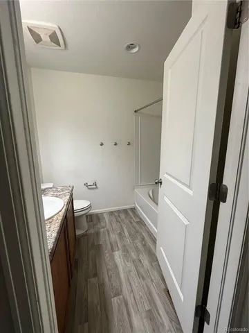 a view of a livingroom with wooden floor