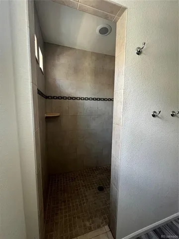 a bathroom with a glass shower door