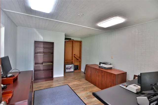a view of outdoor space with a wooden fence and a large tree