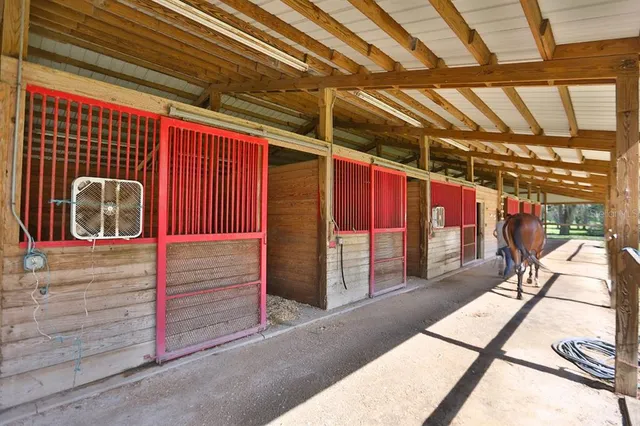 an aerial view of a house with a yard swimming pool and outdoor seating