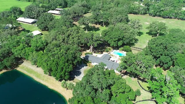a living room with furniture a chandelier and a large window