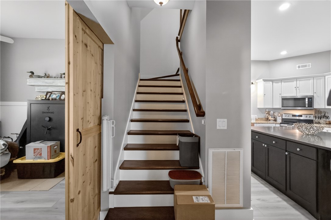 1504 Double Springs Road Townville, SC 29689 - Photo 24 of 41 Elegant wooden staircase and a gourmet kitchen blend seamlessly in this inviting home.