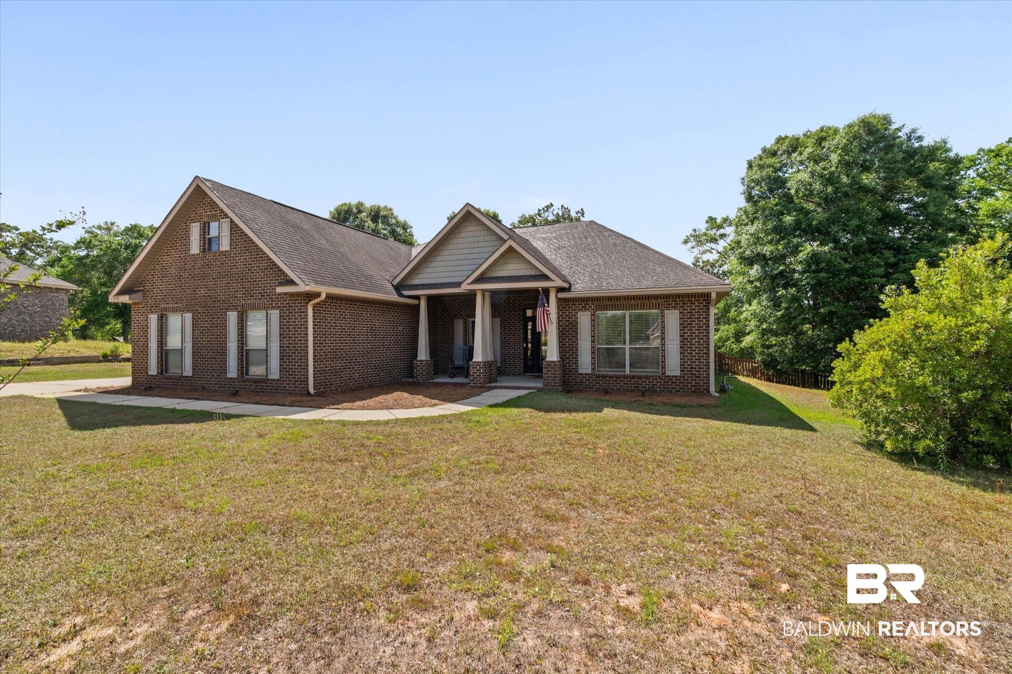 3739 Whitestone Drive Semmes, AL 36575 - Photo 23 of 25 Brick exterior with white window shutters and a front porch featuring columns