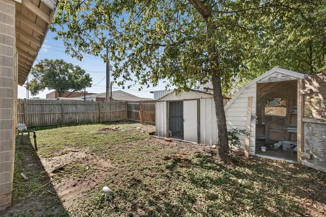 a white kitchen with sink and stove