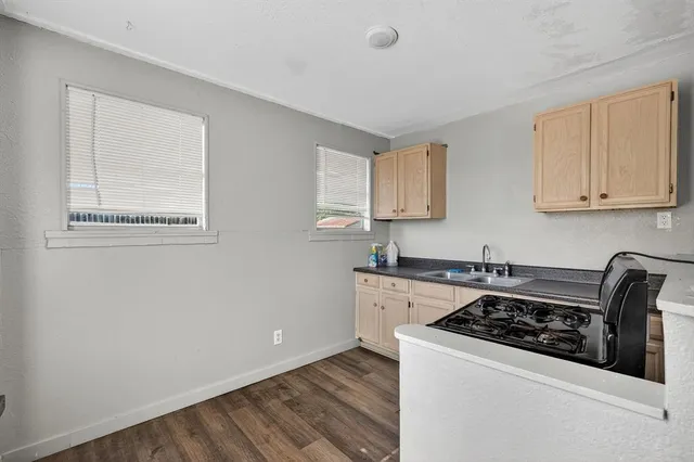 a view of a kitchen with a sink and dishwasher cabinets