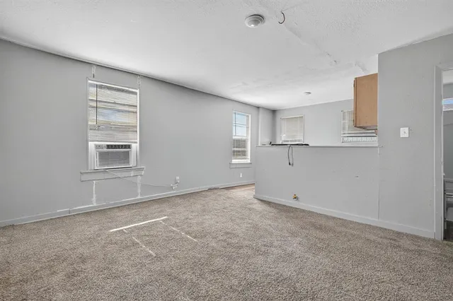 an empty room with windows and closet