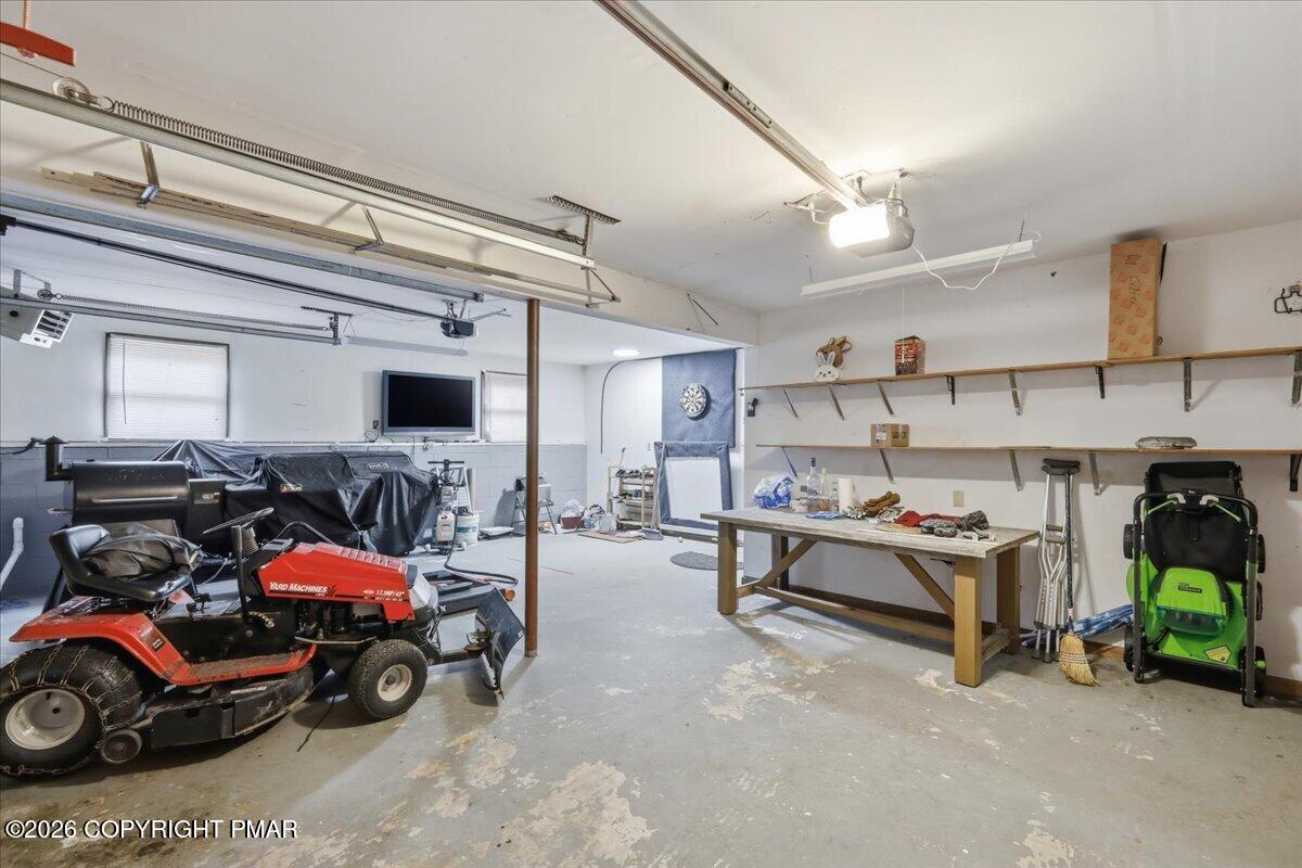 606 Rimrock Road Bartonsville, PA 18321 - Photo 24 of 36 a view of a garage with a white car parked