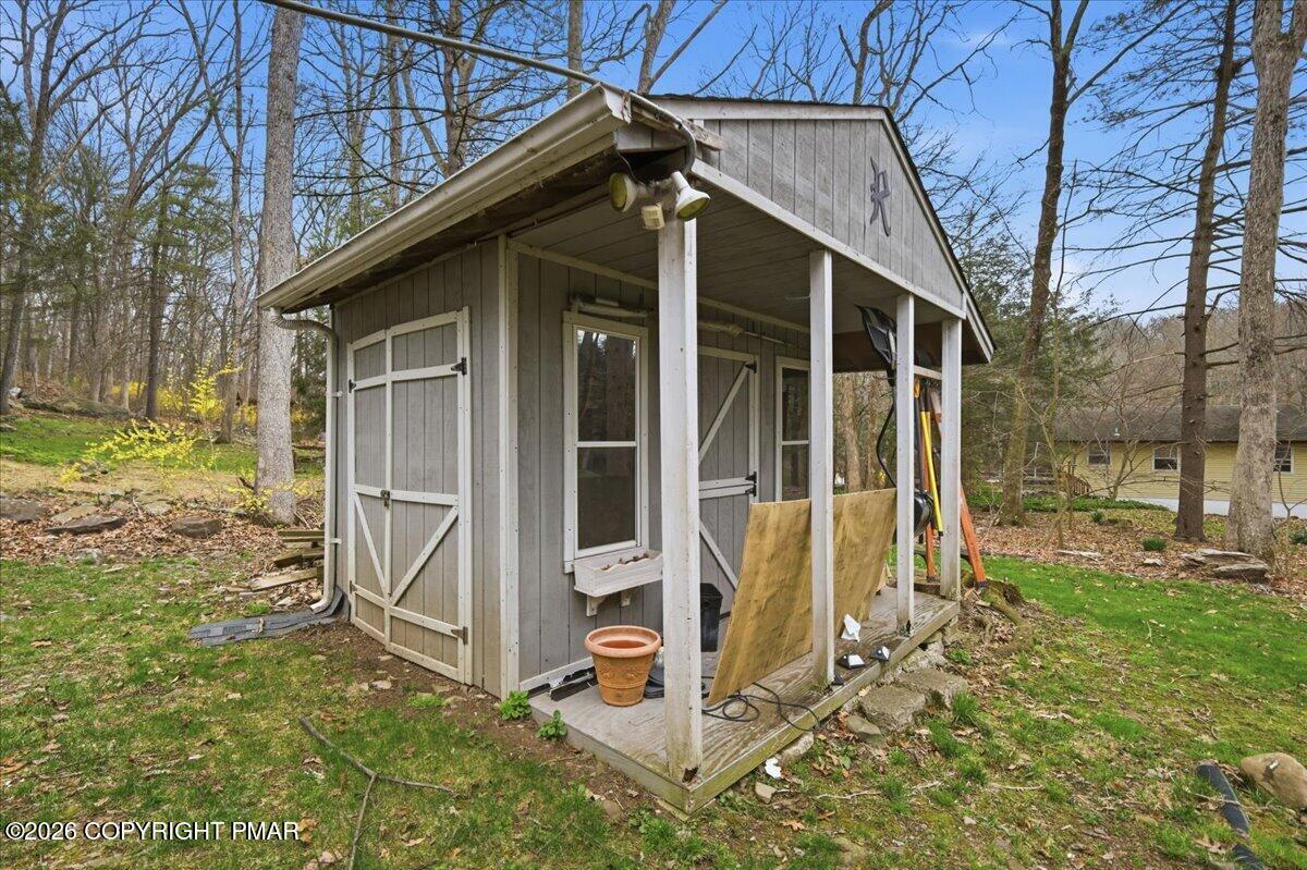 606 Rimrock Road Bartonsville, PA 18321 - Photo 29 of 36 a view of a wooden house with a large window and yard