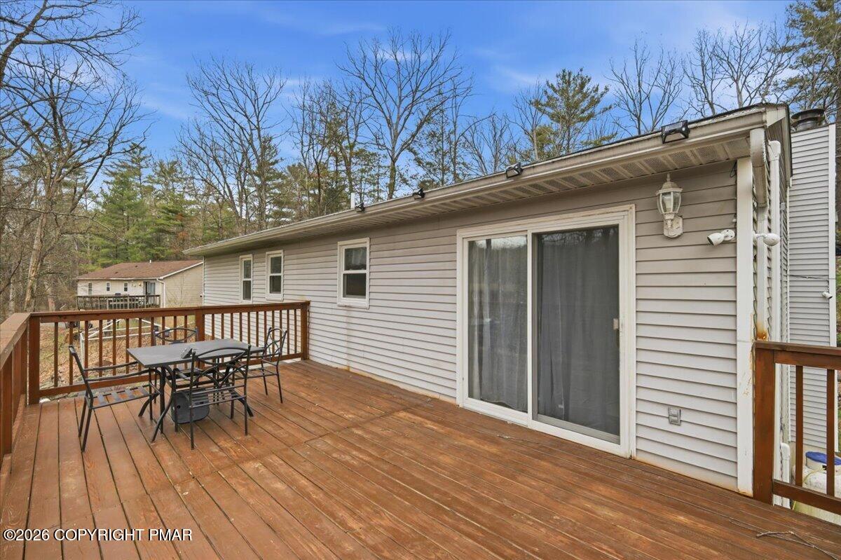 606 Rimrock Road Bartonsville, PA 18321 - Photo 4 of 36 a view of a deck with table and chairs and wooden floor