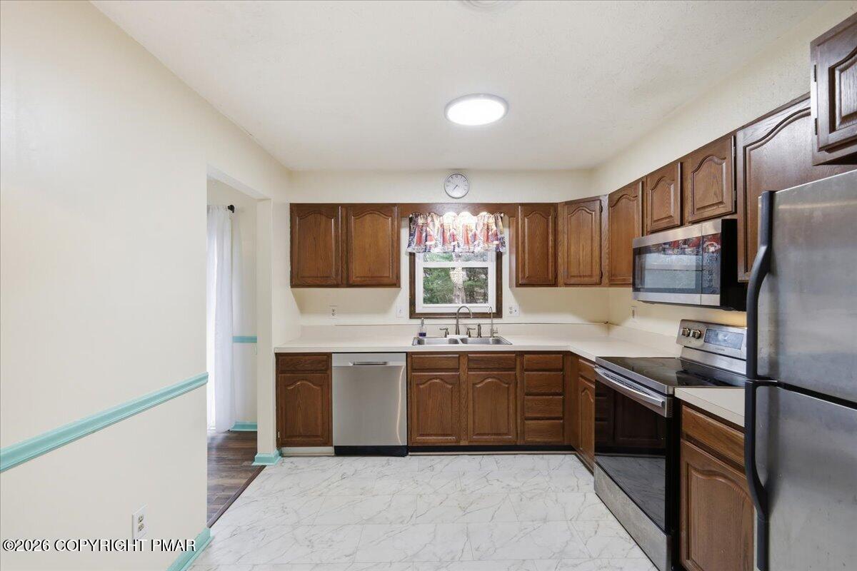 606 Rimrock Road Bartonsville, PA 18321 - Photo 7 of 36 a kitchen with stainless steel appliances granite countertop a sink and stove top oven