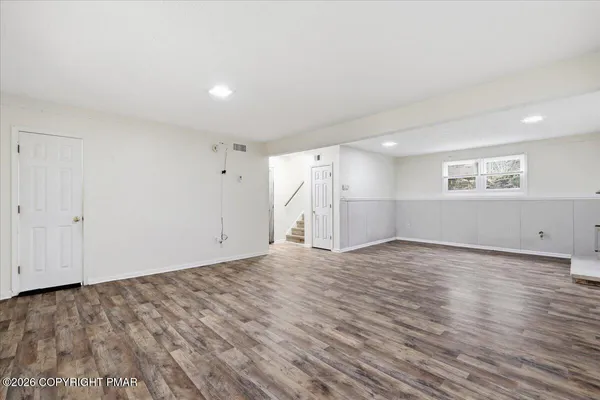 a view of an entryway with wooden floor