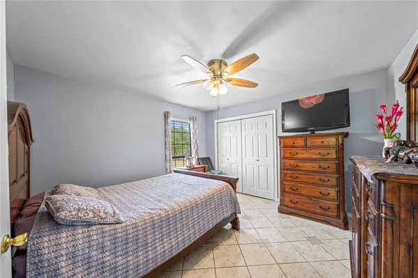 a bedroom with a bed and a window