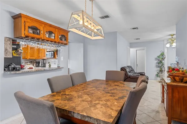 a dining room with furniture and a chandelier