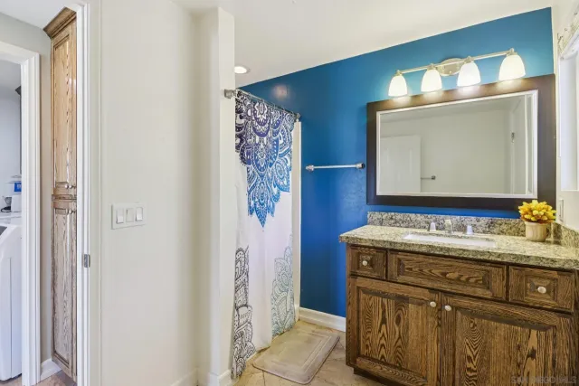 a bathroom with a sink vanity and a mirror