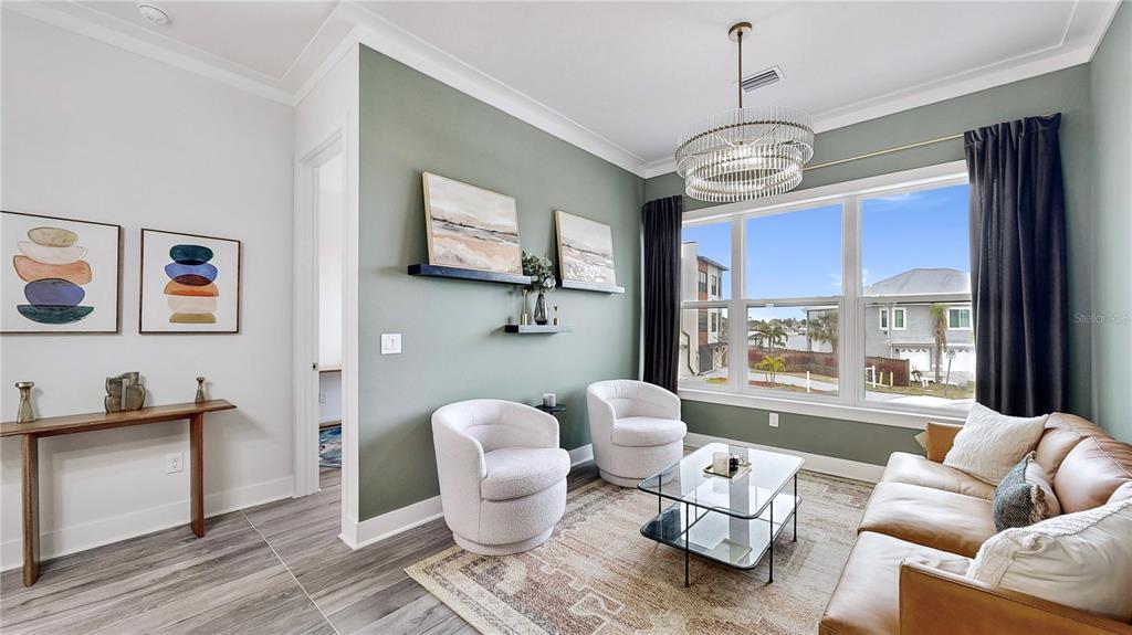 777 Gran Kaymen Way Apollo Beach, FL 33572 - Photo 15 of 30 a living room with furniture a window and a chandelier