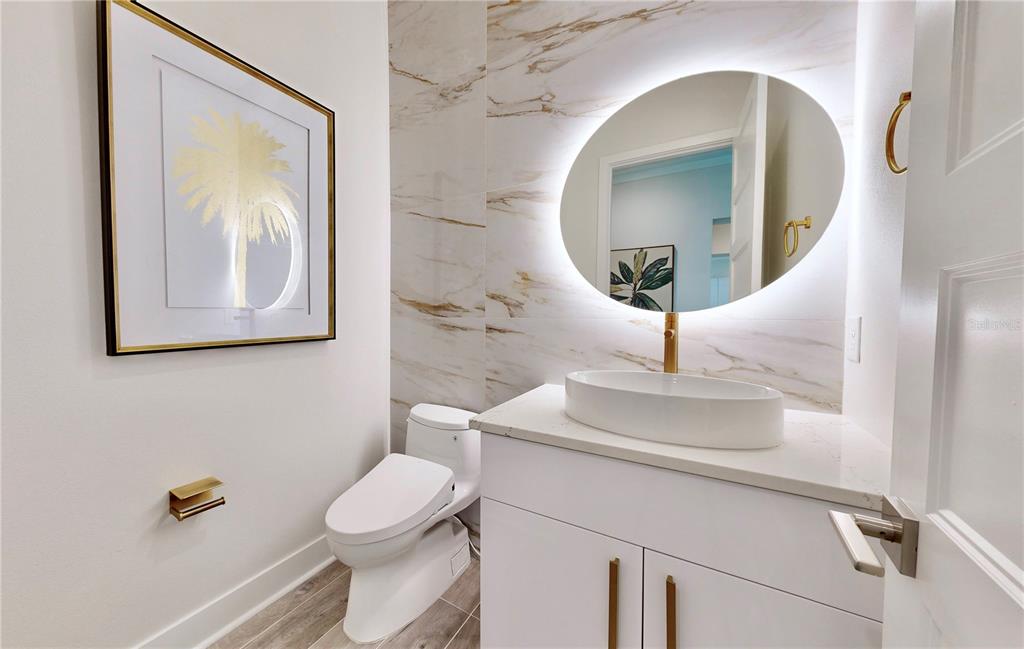 777 Gran Kaymen Way Apollo Beach, FL 33572 - Photo 16 of 30 a bathroom with a toilet a sink and mirror