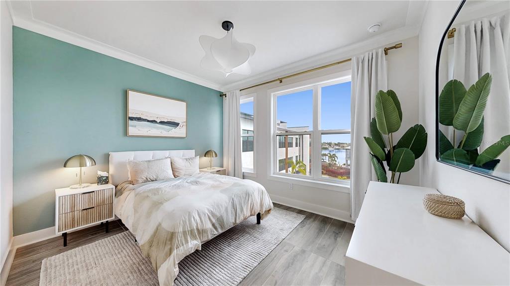 777 Gran Kaymen Way Apollo Beach, FL 33572 - Photo 18 of 30 a bedroom with a bed a potted plant and a window