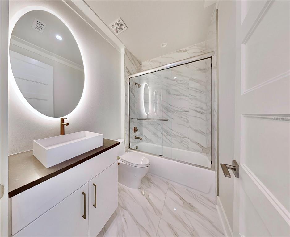 777 Gran Kaymen Way Apollo Beach, FL 33572 - Photo 20 of 30 a bathroom with a toilet a sink and a mirror