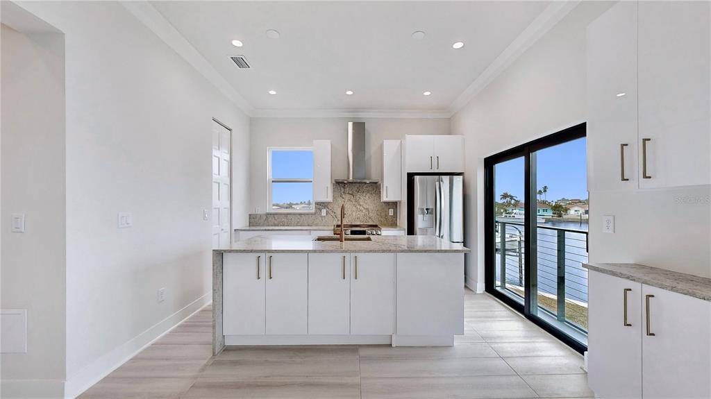 777 Gran Kaymen Way Apollo Beach, FL 33572 - Photo 5 of 30 a kitchen with stainless steel appliances granite countertop a refrigerator a sink and a stove