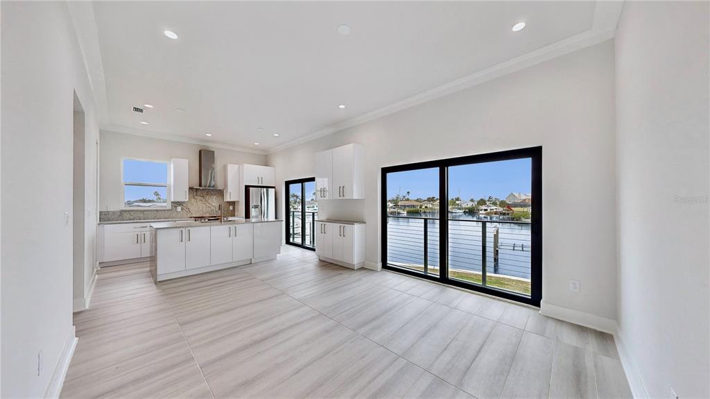 777 Gran Kaymen Way Apollo Beach, FL 33572 - Photo 6 of 30 a open kitchen with white cabinets and wooden floor