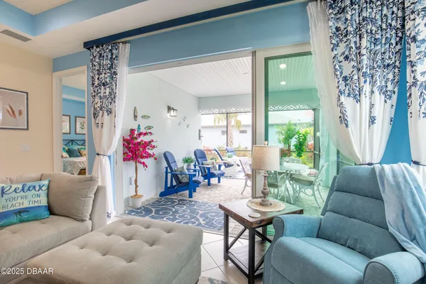 a living room with furniture and a potted plant