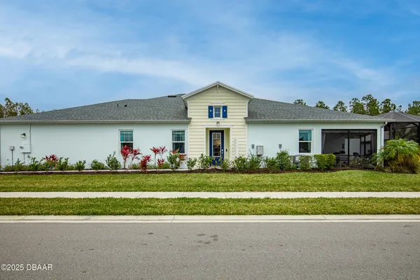 a front view of a house with a garden