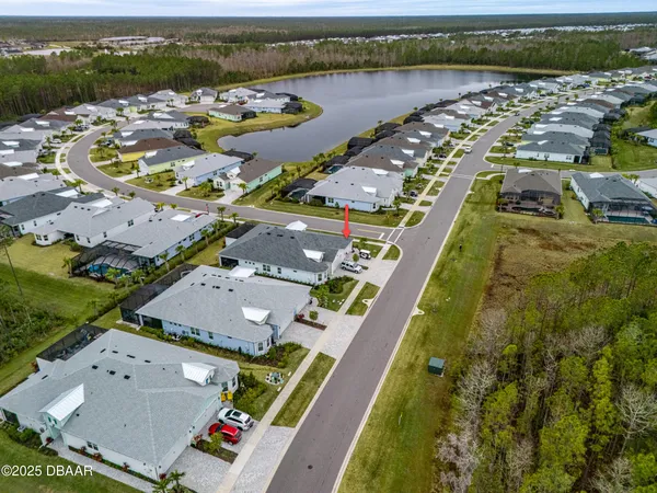 aerial view of a house with a swimming pool and outdoor seating