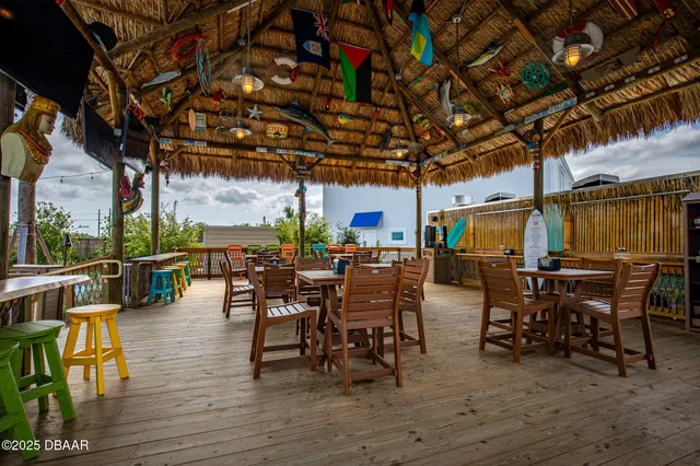a view of a patio with a table and chairs under an umbrella
