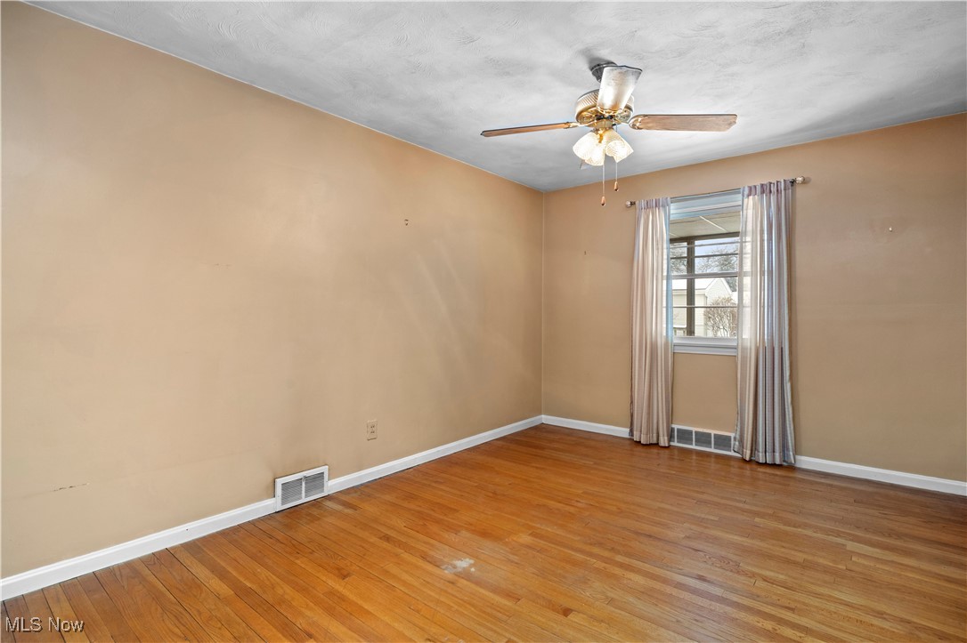 25950 Bagley Road Olmsted Falls, OH 44138 - Photo 7 of 32 Spare room featuring light wood finished floors and ceiling fan