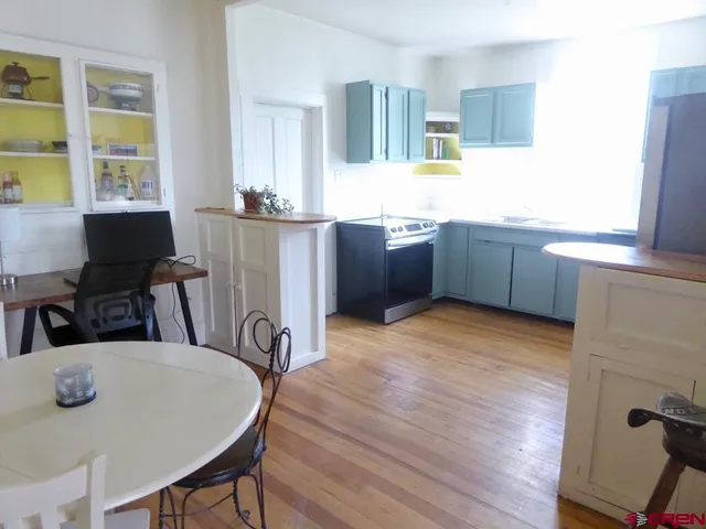 a kitchen with stainless steel appliances a sink a refrigerator and a stove