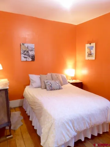 a bed sitting in a bedroom with a bed