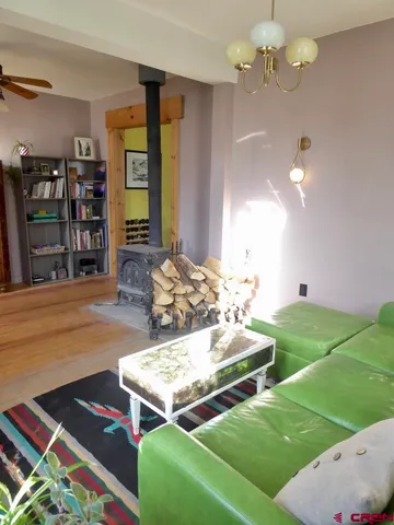 a living room with hard wood flooring and furniture