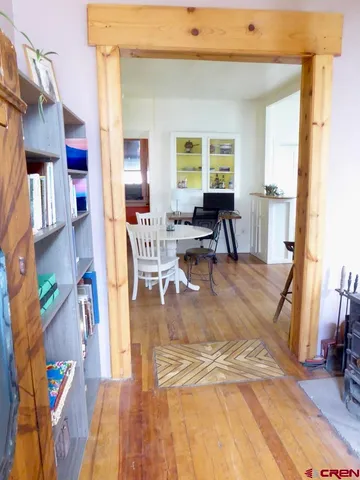 a living room with furniture and a dining table