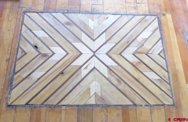 a workspace with furniture and a wooden floor