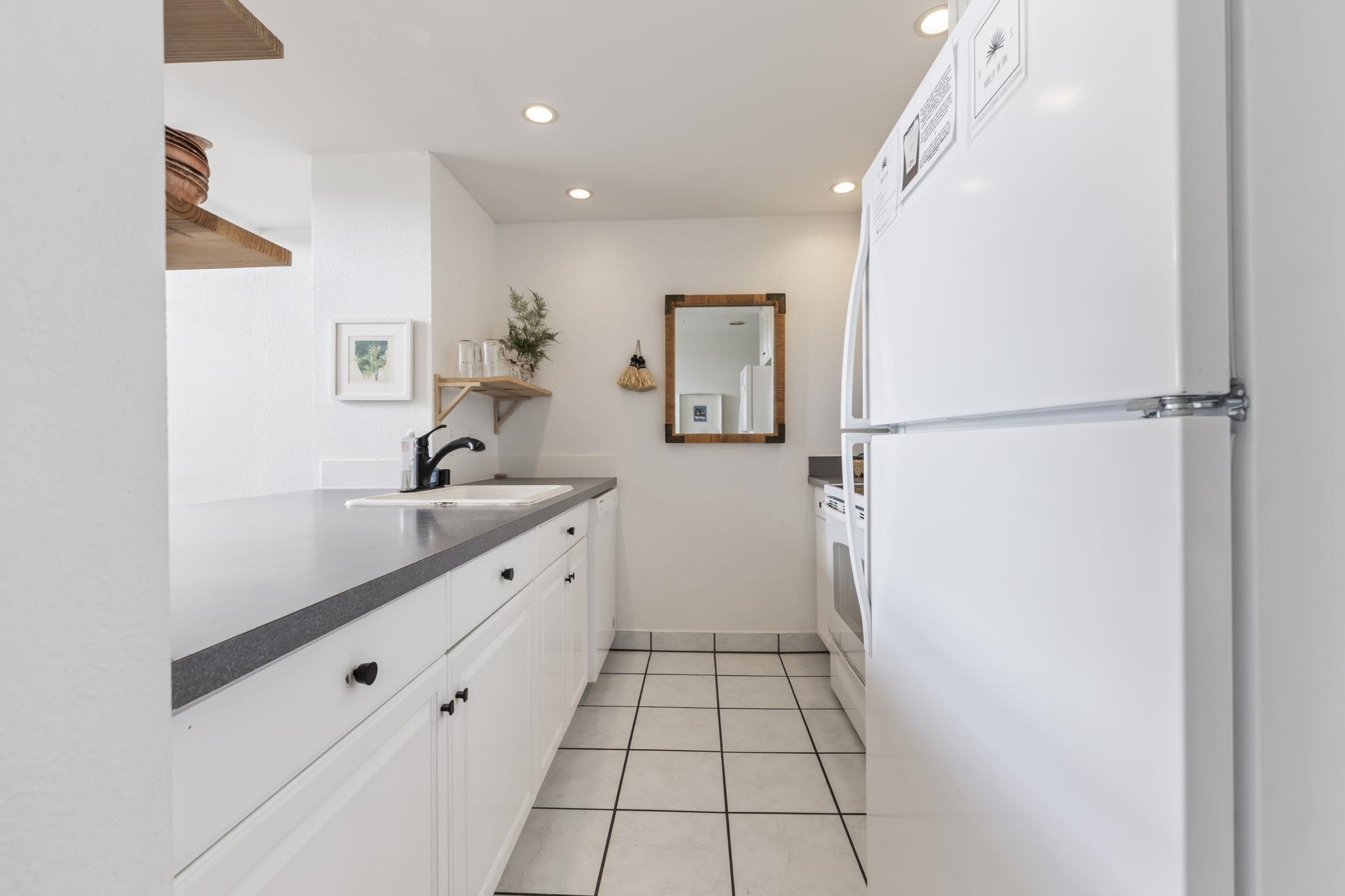 1299 Uluniu Road, Unit G202 Kihei, HI 96753 - Photo 13 of 46 a bathroom with a sink a mirror and a shower