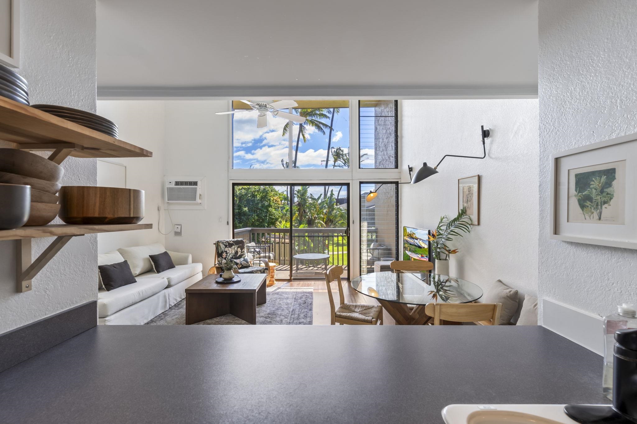 1299 Uluniu Road, Unit G202 Kihei, HI 96753 - Photo 16 of 46 a living room with furniture fireplace and a large window