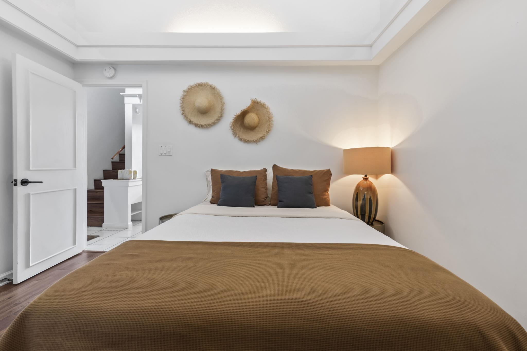 1299 Uluniu Road, Unit G202 Kihei, HI 96753 - Photo 19 of 46 a bedroom with a bed and a lamp on dresser