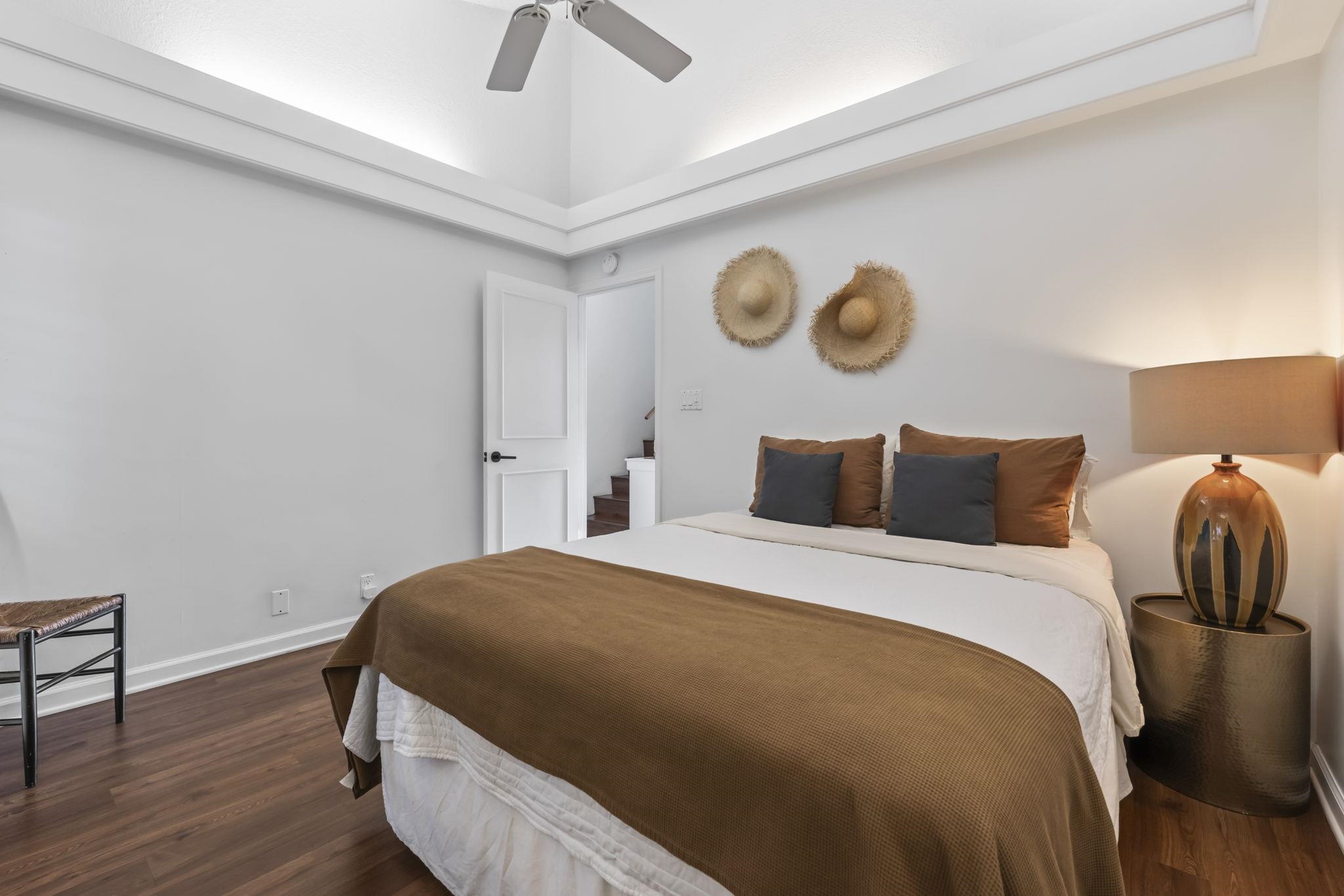 1299 Uluniu Road, Unit G202 Kihei, HI 96753 - Photo 20 of 46 a bedroom with bed and wooden floor