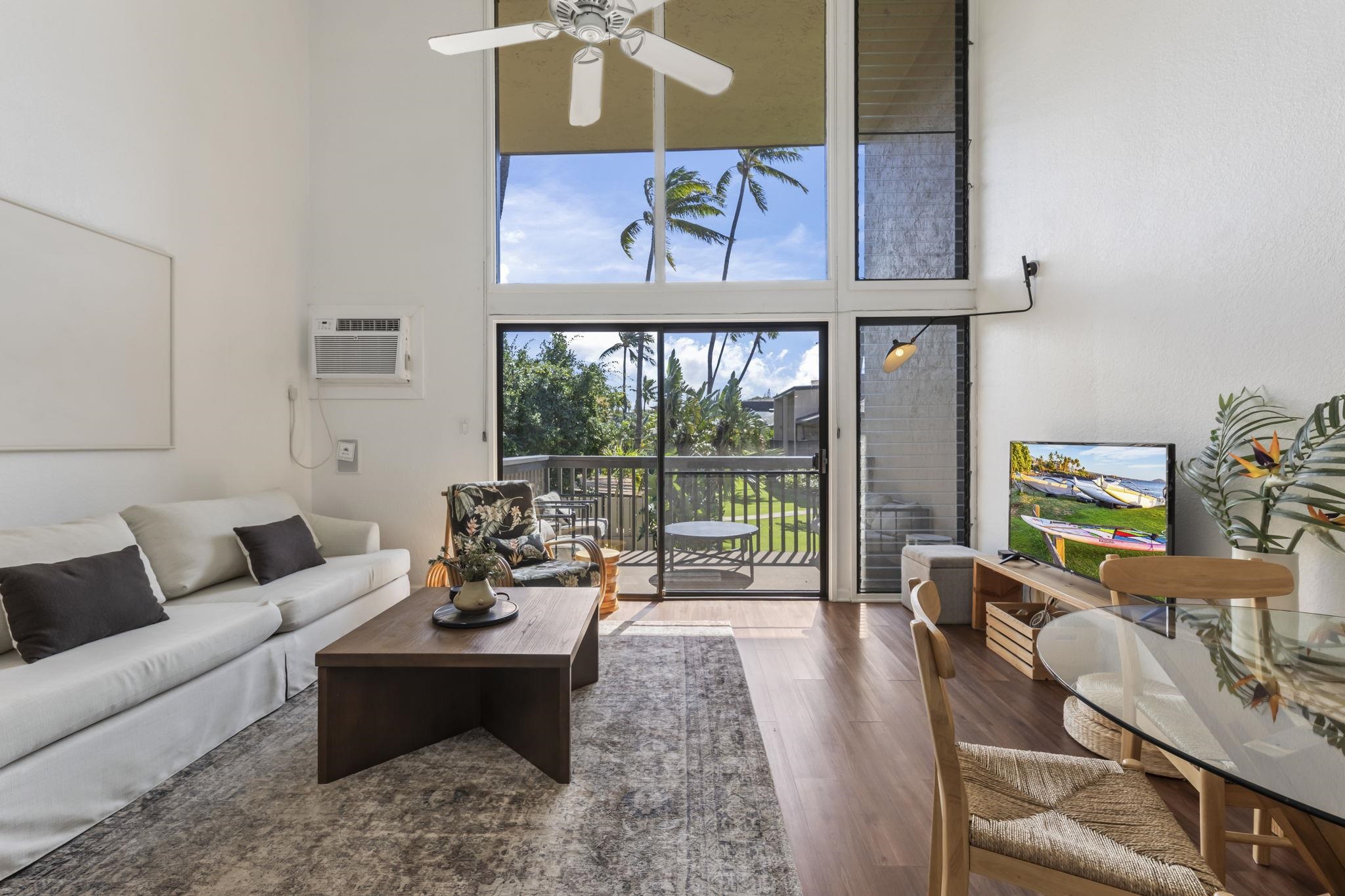 1299 Uluniu Road, Unit G202 Kihei, HI 96753 - Photo 2 of 46 a living room with furniture and a floor to ceiling window