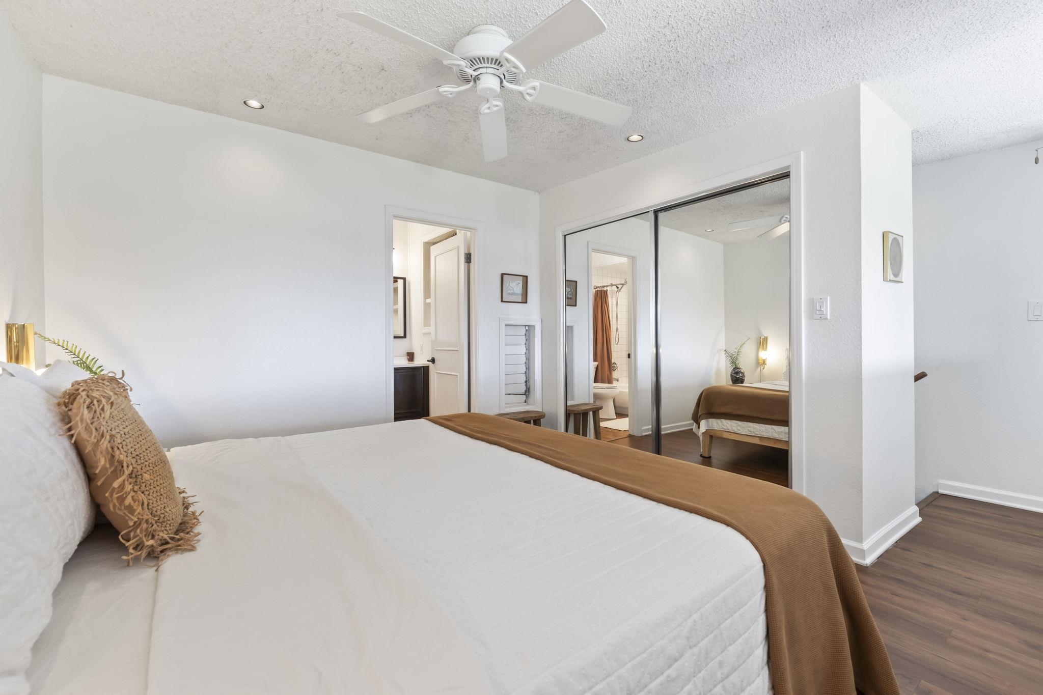 1299 Uluniu Road, Unit G202 Kihei, HI 96753 - Photo 27 of 46 a bedroom with a bed and wooden floor