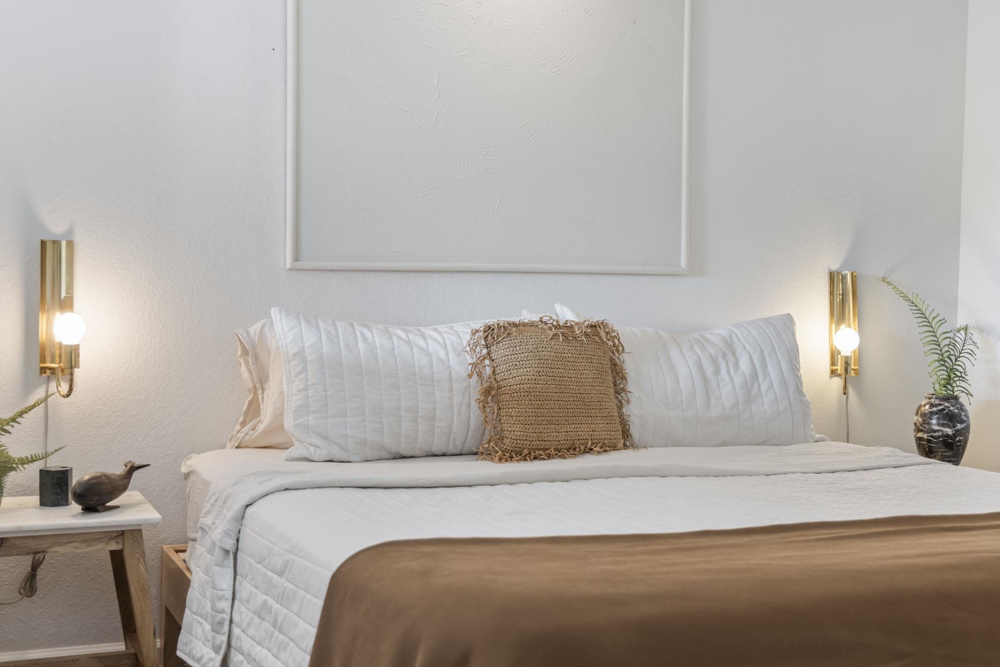 1299 Uluniu Road, Unit G202 Kihei, HI 96753 - Photo 28 of 46 a large bed sitting in a bedroom next to a lamp