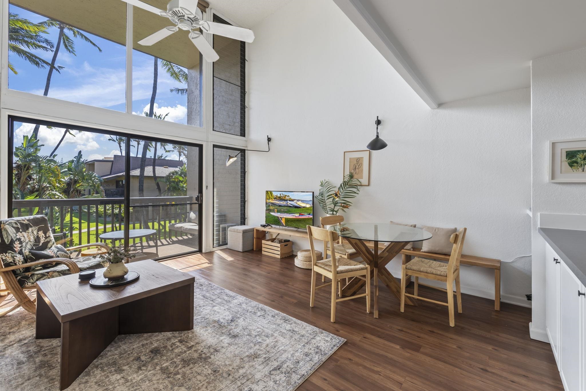 1299 Uluniu Road, Unit G202 Kihei, HI 96753 - Photo 3 of 46 a living room with furniture a large window and wooden floor