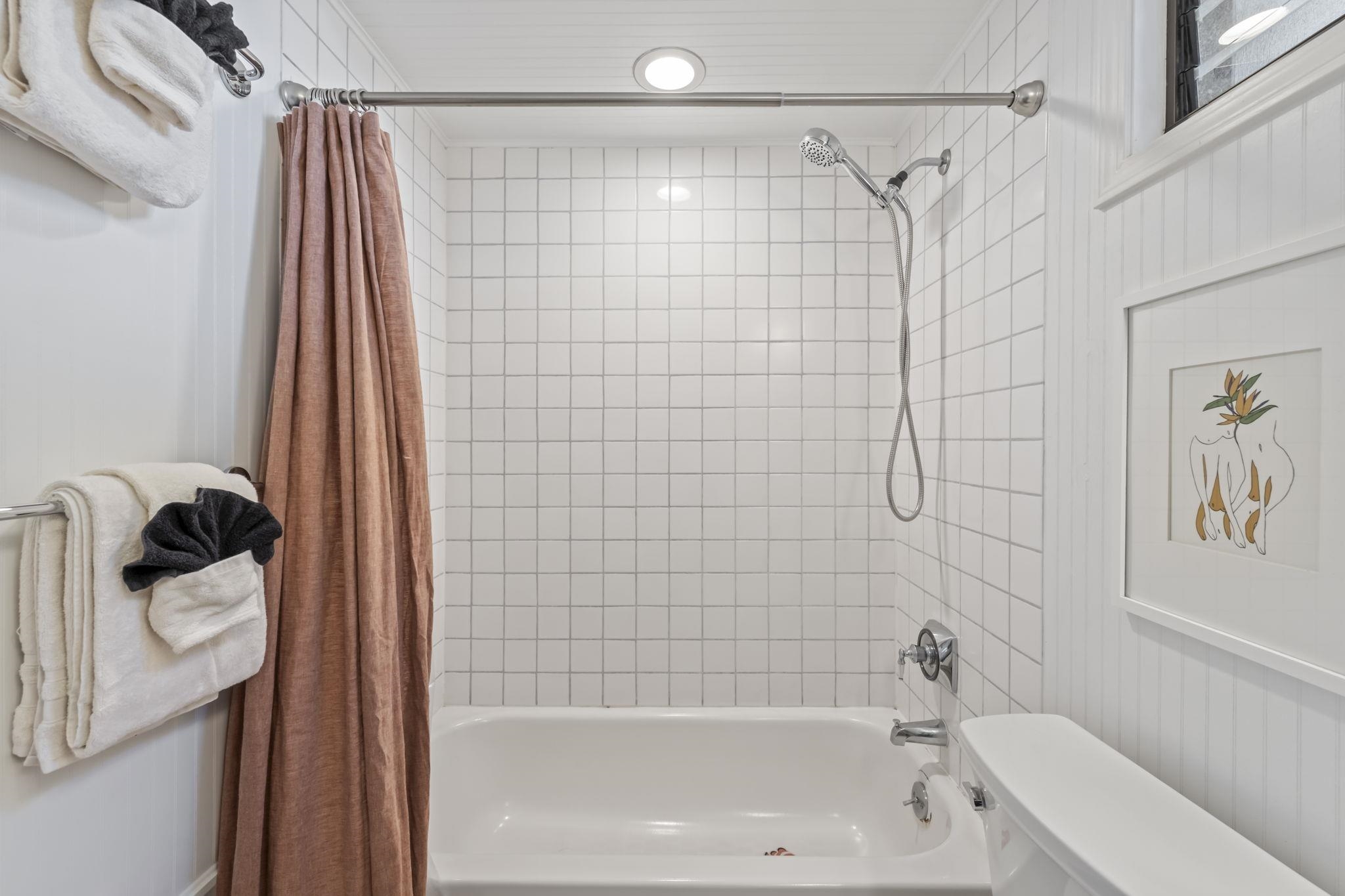 1299 Uluniu Road, Unit G202 Kihei, HI 96753 - Photo 32 of 46 a bathroom with a shower curtain and a bathtub