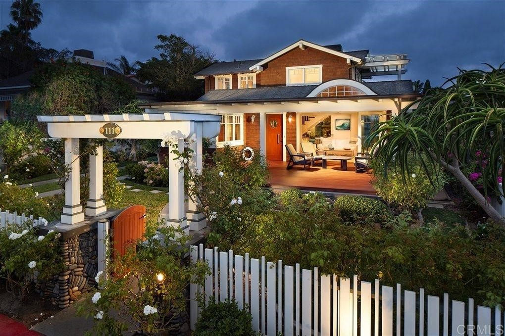 111 10th Street Del Mar, CA 92014 - Photo 2 of 23 a front view of a house with a yard table and chairs