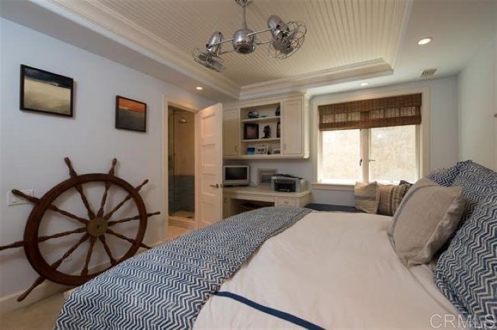 111 10th Street Del Mar, CA 92014 - Photo 15 of 23 a living room with furniture two window and a flat screen tv