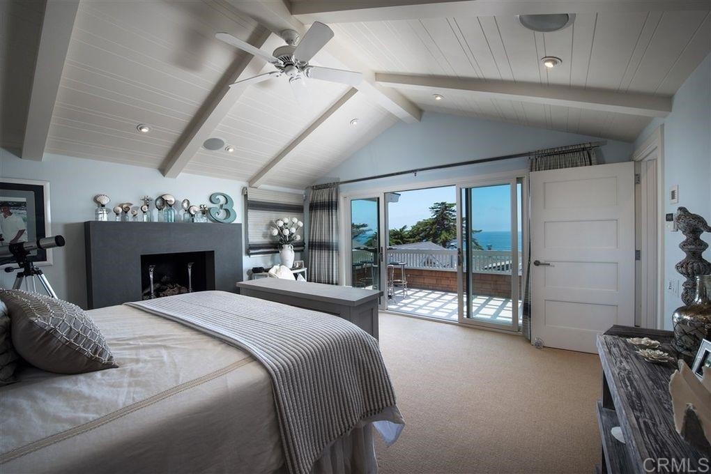 111 10th Street Del Mar, CA 92014 - Photo 23 of 23 a large bedroom with a bed and a fireplace